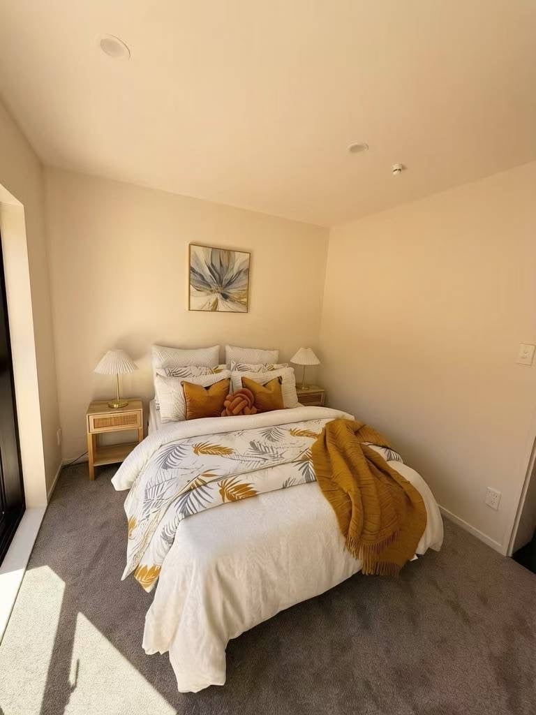 Bedroom staging with warm ochre accents